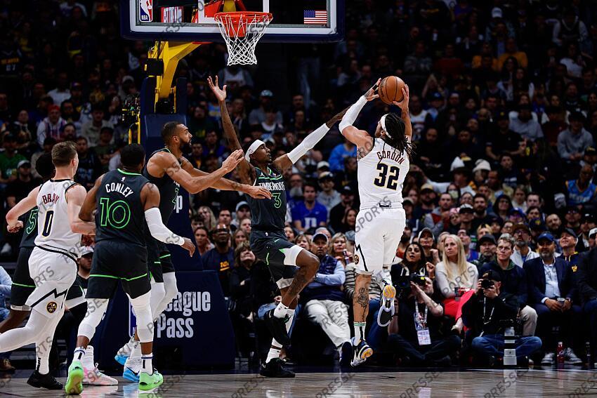 Apr 1, 2025; Denver, Colorado, USA; Denver Nuggets forward Aaron Gordon (32) attempts a shot under pressure from Minnesota Timberwolves forward Jaden McDaniels (3) as center Rudy Gobert (27) and guard Mike Conley (10) and guard Christian Braun (0) defend in the first quarter at Ball Arena. Mandatory Credit: Isaiah J. Downing-Imagn Images NBA: Minnesota Timberwolves at Denver Nuggets 