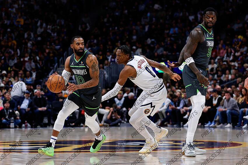 Apr 1, 2025; Denver, Colorado, USA; Minnesota Timberwolves guard Mike Conley (10) controls the ball against Denver Nuggets forward Peyton Watson (8) as forward Julius Randle (30) defends in the first quarter at Ball Arena. Mandatory Credit: Isaiah J. Downing-Imagn Images NBA: Minnesota Timberwolves at Denver Nuggets 