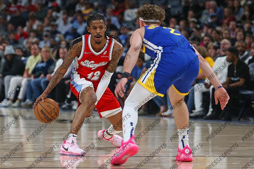 Apr 1, 2025; Memphis, Tennessee, USA; Memphis Grizzlies guard Ja Morant (12) dribbles as Golden State Warriors guard Brandin Podziemski (2) defends during the first quarter at FedExForum. Mandatory Credit: Petre Thomas-Imagn Images NBA: Golden State Warriors at Memphis Grizzlies 