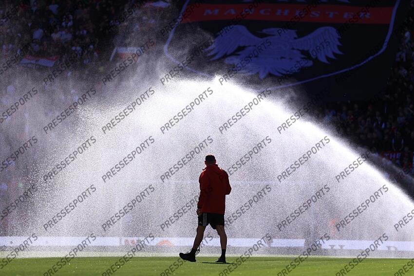 6th April 2025 - Premier League - Manchester United v Manchester City - A member of the grounds staff is silhouetted against the water sprinklers - Photo: Simon Stacpoole / Offside. MANCHESTER UNITED-MANCHESTER CITY (0-0) 