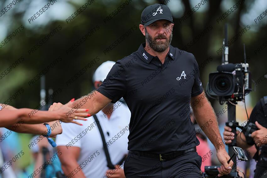 Apr 5, 2025; Miami, Florida, USA; Dustin Johnson fist pumps with fans on his way to the fifth tee during the second round of the LIV Golf Miami golf tournament at Trump National Doral. Mandatory Credit: Sam Navarro-Imagn Images Golf: LIV Golf Miami - Second Round 