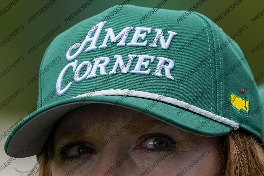 Apr 5, 2025; Augusta, Georgia, USA; A patron wears an Amen Corner hat on the 13th hole during the final round of the Augusta National Women's Amateur golf tournament at Augusta National Golf Club. Mandatory Credit: Michael Madrid-Imagn Images Golf: Augusta National Women's Amateur - Final Round 
