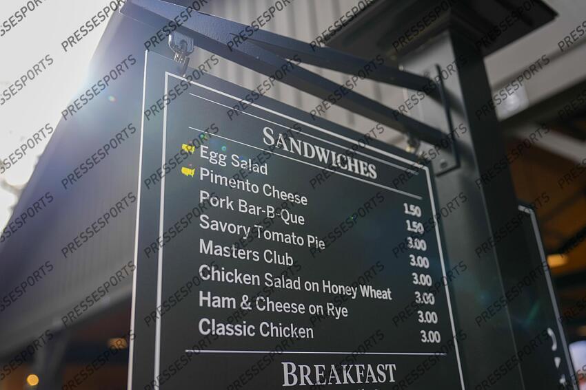 Apr 5, 2025; Augusta, Georgia, USA; A menu hangs in a concession area along the eighth hole during the final round of the Augusta National Women's Amateur golf tournament at Augusta National Golf Club. Mandatory Credit: Katie Goodale-Imagn Images Golf: Augusta National Women's Amateur - Final Round 