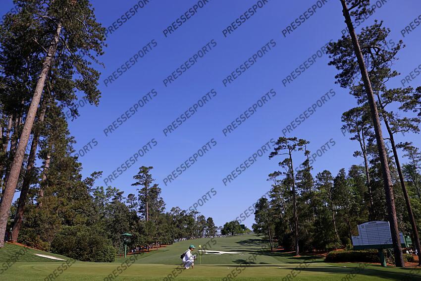 Apr 9, 2025; Augusta, Georgia, USA; Shota Hayafuji, caddy for Hideki Matsuyama checks the yardage on the tenth fairway during a practice round for the Masters Tournament at Augusta National Golf Club. Mandatory Credit: Peter Casey-Imagn Images PGA: Masters Tournament - Practice Round 