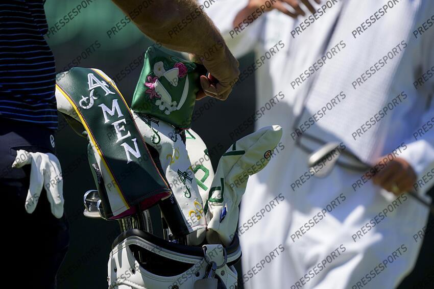 Apr 8, 2025; Augusta, Georgia, USA; Dustin Johnson adjusts his club cover on the no. 5 green during a practice round for the Masters Tournament at Augusta National Golf Club. Mandatory Credit: Grace Smith-Imagn Images PGA: Masters Tournament - Practice Round 