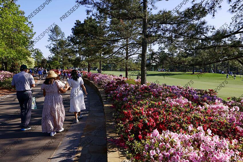 Apr 8, 2025; Augusta, Georgia, USA; Patrons walk along the azaleas during a practice round for the Masters Tournament at Augusta National Golf Club. Mandatory Credit: Peter Casey-Imagn Images PGA: Masters Tournament - Practice Round 