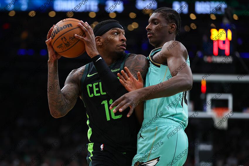 Apr 13, 2025; Boston, Massachusetts, USA; Boston Celtics forward Torrey Craig (12) looks to pass defended by Charlotte Hornets forward Moussa Diabate (14) during the first half at TD Garden. Mandatory Credit: Paul Rutherford-Imagn Images NBA: Charlotte Hornets at Boston Celtics 