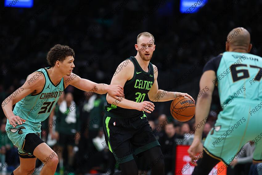 Apr 13, 2025; Boston, Massachusetts, USA; Boston Celtics forward Sam Hauser (30) dribbles down the court defended by Charlotte Hornets forward Tidjane Salaun (31) during the first half at TD Garden. Mandatory Credit: Paul Rutherford-Imagn Images NBA: Charlotte Hornets at Boston Celtics 