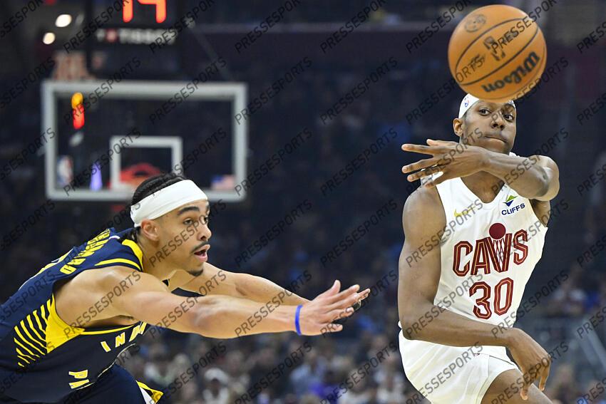 Apr 13, 2025; Cleveland, Ohio, USA; Cleveland Cavaliers forward Nae'Qwan Tomlin (30) throws a pass beside Indiana Pacers guard Andrew Nembhard (2) in the first quarter at Rocket Arena. Mandatory Credit: David Richard-Imagn Images NBA: Indiana Pacers at Cleveland Cavaliers 