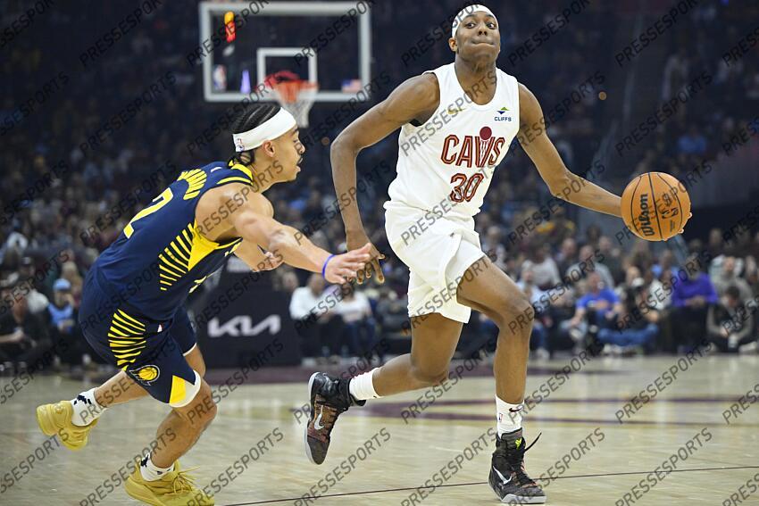 Apr 13, 2025; Cleveland, Ohio, USA; Cleveland Cavaliers forward Nae'Qwan Tomlin (30) dribbles beside Indiana Pacers guard Andrew Nembhard (2) in the first quarter at Rocket Arena. Mandatory Credit: David Richard-Imagn Images NBA: Indiana Pacers at Cleveland Cavaliers 