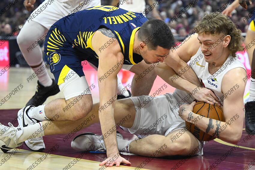 Apr 13, 2025; Cleveland, Ohio, USA; Indiana Pacers guard T.J. McConnell (9) and Cleveland Cavaliers guard Luke Travers (33) reach for a loose ball in the first quarter at Rocket Arena. Mandatory Credit: David Richard-Imagn Images NBA: Indiana Pacers at Cleveland Cavaliers 