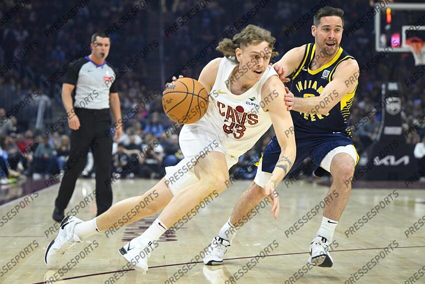 Apr 13, 2025; Cleveland, Ohio, USA; Cleveland Cavaliers guard Luke Travers (33) dribbles beside Indiana Pacers guard T.J. McConnell (9) in the first quarter at Rocket Arena. Mandatory Credit: David Richard-Imagn Images NBA: Indiana Pacers at Cleveland Cavaliers 