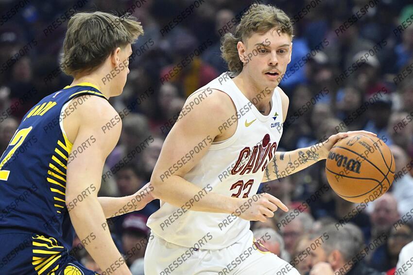 Apr 13, 2025; Cleveland, Ohio, USA; Cleveland Cavaliers guard Luke Travers (33) dribbles beside Indiana Pacers forward Johnny Furphy (12) in the first quarter at Rocket Arena. Mandatory Credit: David Richard-Imagn Images NBA: Indiana Pacers at Cleveland Cavaliers 
