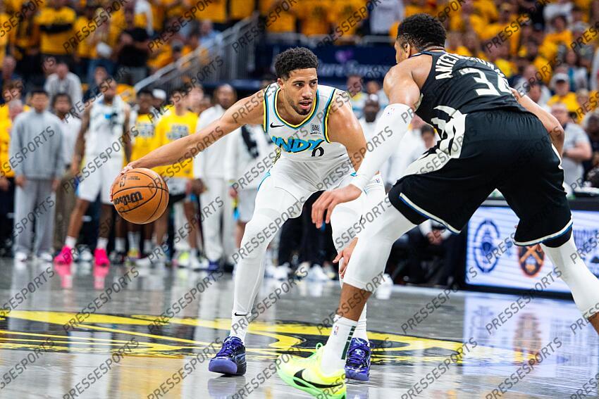 Apr 29, 2025; Indianapolis, Indiana, USA; Indiana Pacers guard Tyrese Haliburton (0) dribbles the ball while Milwaukee Bucks forward Giannis Antetokounmpo (34) defends during game five of the first round for the 2024 NBA Playoffs at Gainbridge Fieldhouse. Mandatory Credit: Trevor Ruszkowski-Imagn Images NBA: Playoffs-Milwaukee Bucks at Indiana Pacers 