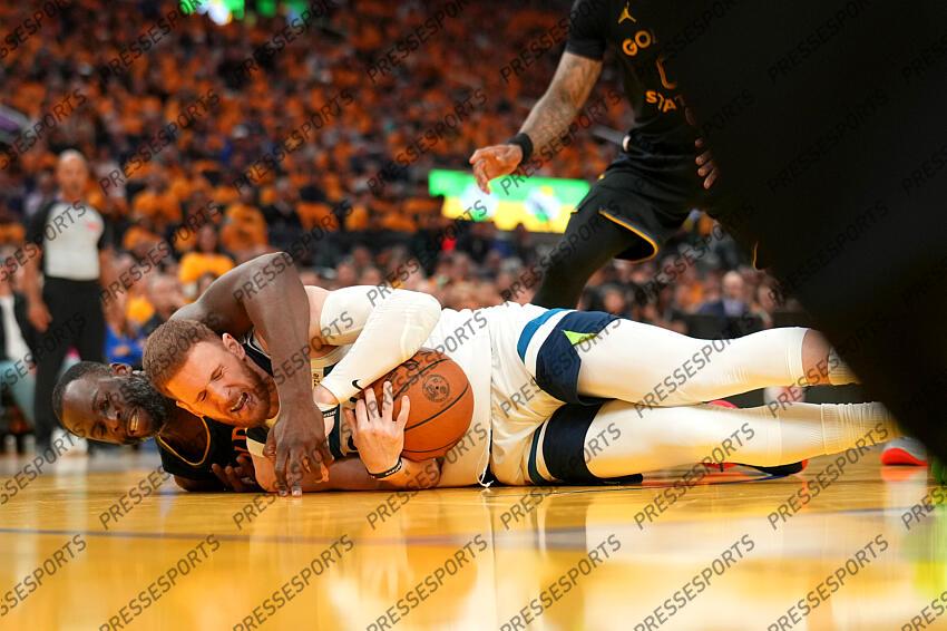 May 12, 2025; San Francisco, California, USA; Minnesota Timberwolves guard Donte DiVincenzo (0) gains control of a loose ball next to Golden State Warriors forward Draymond Green (23) in the second quarter during game four of the second round for the 2025 NBA Playoffs at Chase Center. Mandatory Credit: Cary Edmondson-Imagn Images NBA: Playoffs-Minnesota Timberwolves at Golden State Warriors 