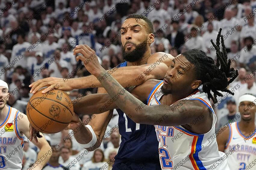 May 26, 2025; Minneapolis, Minnesota, USA; Minnesota Timberwolves center Rudy Gobert (27) attempts to shoot the ball against Oklahoma City Thunder guard Cason Wallace (22) in the second half during game four of the western conference finals for the 2025 NBA Playoffs at Target Center. Mandatory Credit: Bruce Kluckhohn-Imagn Images NBA: Playoffs-Oklahoma City Thunder at Minnesota Timberwolves 
