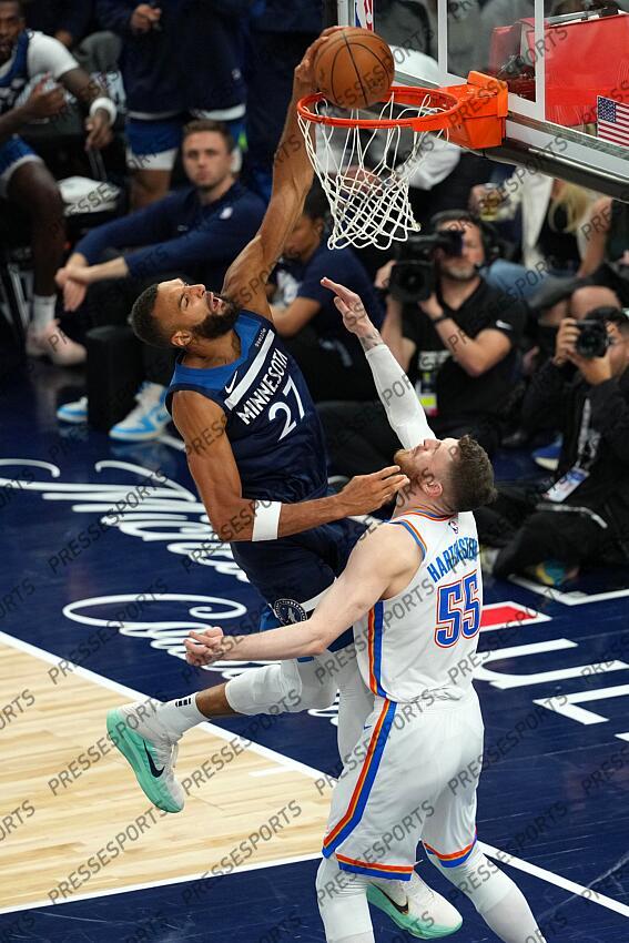 May 26, 2025; Minneapolis, Minnesota, USA; Minnesota Timberwolves center Rudy Gobert (27) dunks the ball over Oklahoma City Thunder center Isaiah Hartenstein (55) in the second half during game four of the western conference finals for the 2025 NBA Playoffs at Target Center. Mandatory Credit: Jesse Johnson-Imagn Images NBA: Playoffs-Oklahoma City Thunder at Minnesota Timberwolves 