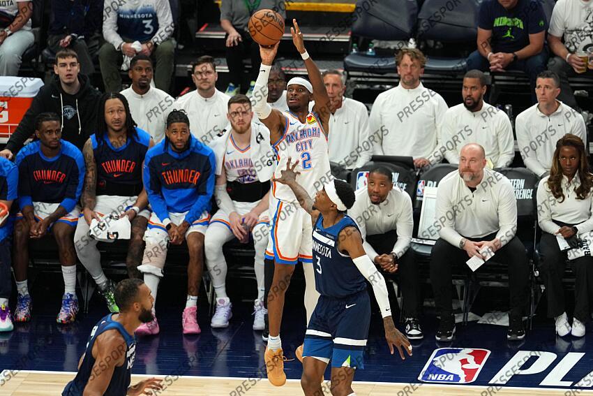 May 26, 2025; Minneapolis, Minnesota, USA; Oklahoma City Thunder guard Shai Gilgeous-Alexander (2) shoots the ball against Minnesota Timberwolves forward Jaden McDaniels (3) in the second half during game four of the western conference finals for the 2025 NBA Playoffs at Target Center. Mandatory Credit: Jesse Johnson-Imagn Images NBA: Playoffs-Oklahoma City Thunder at Minnesota Timberwolves 