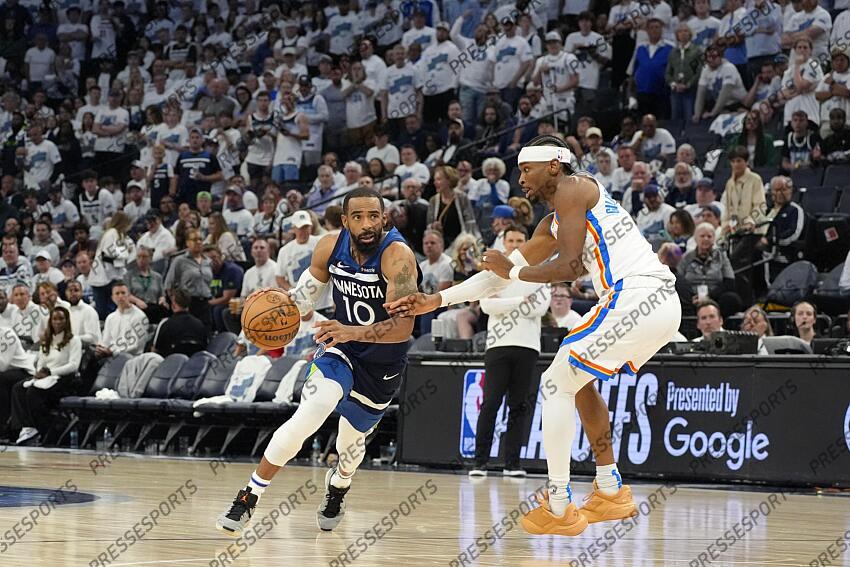 May 26, 2025; Minneapolis, Minnesota, USA; Minnesota Timberwolves guard Mike Conley (10) dribbles the ball past Oklahoma City Thunder guard Shai Gilgeous-Alexander (2) in the second half during game four of the western conference finals for the 2025 NBA Playoffs at Target Center. Mandatory Credit: Bruce Kluckhohn-Imagn Images NBA: Playoffs-Oklahoma City Thunder at Minnesota Timberwolves 