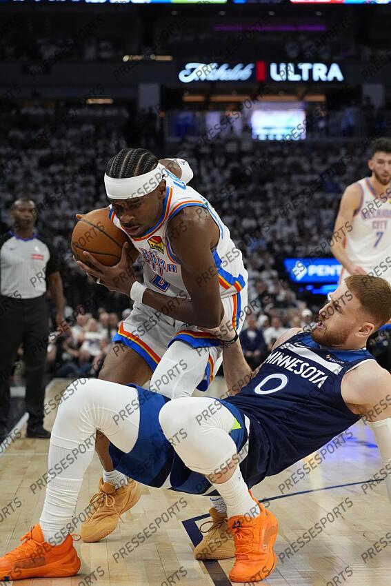 May 26, 2025; Minneapolis, Minnesota, USA; Oklahoma City Thunder guard Shai Gilgeous-Alexander (2) attempts to dribble the ball past Minnesota Timberwolves guard Donte DiVincenzo (0) in the first half during game four of the western conference finals for the 2025 NBA Playoffs at Target Center. Mandatory Credit: Bruce Kluckhohn-Imagn Images NBA: Playoffs-Oklahoma City Thunder at Minnesota Timberwolves 